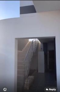 a stairway in a building with a stair railing at Pluto Guesthouse in Walvis Bay