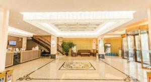 a large lobby with a living room and a staircase at GreenTree Alliance Disneyland North Gate in Shanghai