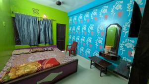 a bedroom with a bed and a mirror at Ashirbad hotel in Digha +10 photos