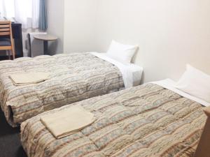 Rúm í herbergi á Oustat Kokusai Hotel Tajimi