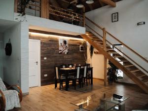 a dining room with a table and a staircase at Cabana Engadin in Borlova