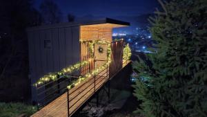 a clock on a deck with christmas lights at Panoramic Box in Vişeu de Sus