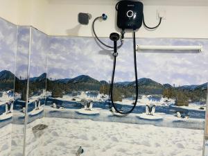 a bathroom with a shower with penguins in the snow at Nine arch eco Villa Ella in Ella +46 photos