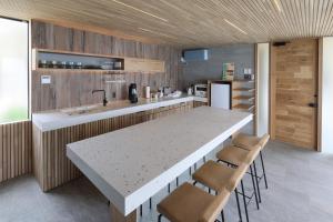 a kitchen with a large white table and chairs at KONA RESORT AWAJI KAI in Awaji