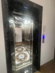 a glass elevator with a tile inside of it at Huy hoang hotel 