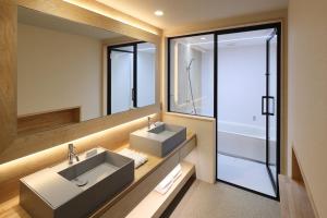 a bathroom with two sinks and a large mirror at KONA RESORT AWAJI KAI in Awaji