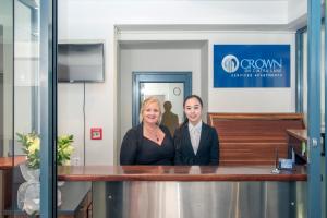 a man and a woman standing at a counter at Crown on Cintra Lane in Auckland