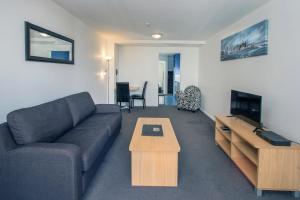 a living room with a couch and a coffee table at Crown on Cintra Lane in Auckland