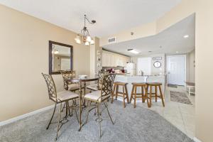 a kitchen and dining room with a table and chairs at Beach Club Condos in Gulf Shores +69 photos