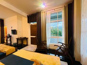 a living room with a table and a window at Ayos Hill Adam's Peak Free Shuttle in Nallathanniya