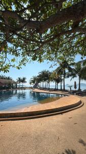 a pool of water with trees and a beach at Little Bailan Retreat - Garden & River Side in Ban Bang Bao