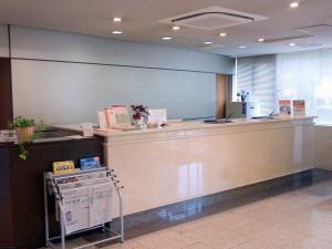 a lobby with a counter and a cash register at Okaya Central Hotel in Okaya