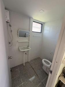 a bathroom with a toilet and a sink at ต้นตาล&ตาลฟ้า รีสอร์ท in Ban Nong Khang