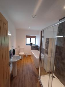 a bathroom with a shower and a sink and a tub at Auld Hoose in Kirkwall