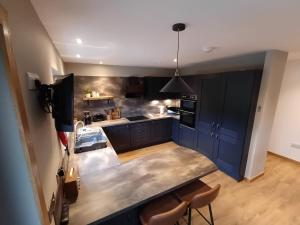 a kitchen with blue cabinets and a counter top at Auld Hoose in Kirkwall
