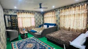 a living room with a couch and a bed and curtains at HOTEL MERLIN RIVER view in Srinagar