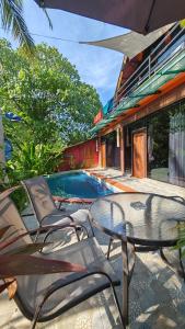 a patio with a table and chairs next to a pool at RELAX ECO Life Center-Khao Lak in Khao Lak