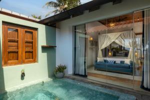 a villa with a swimming pool and a bedroom at Oruva Beachside Villa in Galle +26 photos