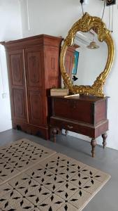 a mirror sitting on top of a dresser in a room at Aqua Vista Studio Appartment in Tangalle +20 photos