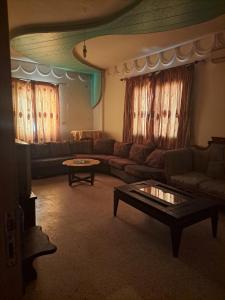 a living room with a couch and a table at Chez SAMAR 