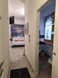 a hallway leading to a bedroom with a bed at Portico 32 - Merano centro in Merano +8 photos