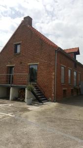 a red brick building with a staircase on it at Le Manoir d'Eole in Steenbecque