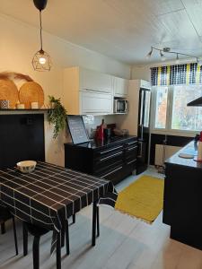 a kitchen with a table and a counter top at Iso kolmio Torniossa in Tornio