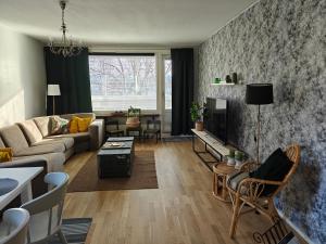 a living room with a couch and a table at Iso kolmio Torniossa in Tornio