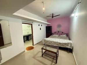 a bedroom with a bed and a table in it at Trippy Turtle in Arambol