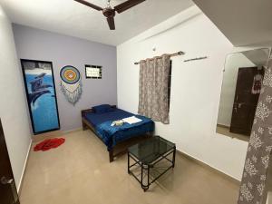 a bedroom with a bed and a table and a mirror at Trippy Turtle in Arambol