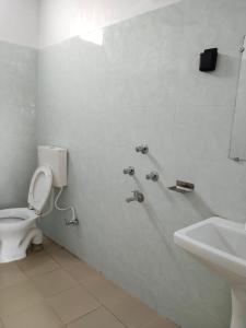 a bathroom with a toilet and a sink at Chaps le guest house in Patna