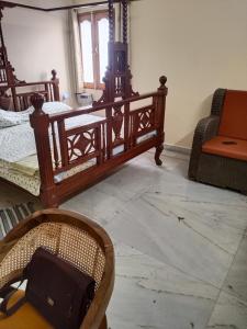 a room with two beds and a table and a chair at Chaps le guest house in Patna