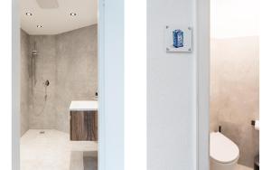 een badkamer met een toilet, een wastafel en een douche bij Das Nordberg Guesthouse in Garmisch-Partenkirchen +59 foto's