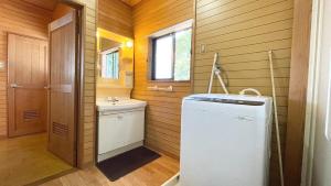 a small bathroom with a washer and dryer in it at Balistyle Tateyama View in Tateyama +6 photos