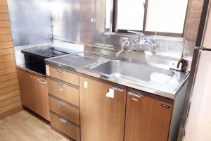 a kitchen with a stainless steel sink and a window at Balistyle Tateyama View in Tateyama