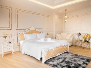 a bedroom with a large white bed and a couch at Louis Residence Hotel in Nakhon Ratchasima +55 photos
