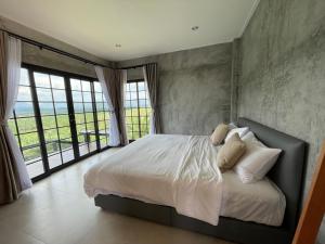 Ένα ή περισσότερα κρεβάτια σε δωμάτιο στο Por Sampao Camp&Resort