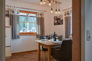 a dining room with a table with wine glasses on it at Braito's Seaside Lodges und Suites, Ferienhäuser und Ferienwohnungen in Haldensee +55 photos