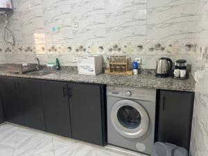 een keuken met een wasmachine en een wastafel bij Luxury University Apartment 3 in Fès