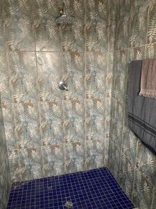 a shower with a tiled wall in a bathroom at ALMiRTY GUEST HOUSE in Grasmere