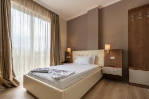 Postel nebo postele na pokoji v ubytování KEIT Hotel