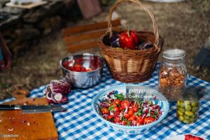 a table with a basket of vegetables and a plate of food at Nicarè Rooms in Agrigento