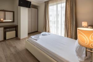 Postel nebo postele na pokoji v ubytování KEIT Hotel