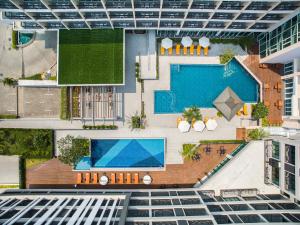 an overhead view of a building with a swimming pool at J Inspired Hotel Pattaya - SHA Extra Plus in Pattaya