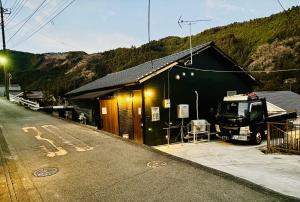 a truck parked in front of a building with a house at Tokurajyo - Vacation STAY 15813 in Akiruno