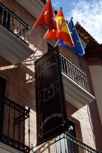 a street sign with a fire hydrant in front of a building at Hotel Complutense in Alcalá de Henares