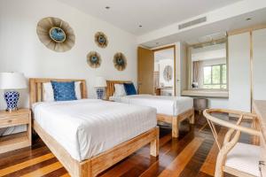 Giường trong phòng chung tại WEG Laguna Residence +23 ảnh