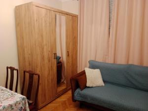 een woonkamer met een blauwe bank en een spiegel bij E-Brechta in Warschau