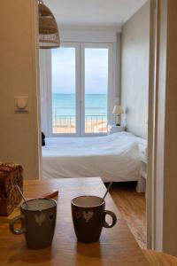 En eller flere senge i et værelse på Le phare face à la mer Vue incroyable