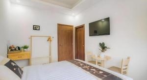 ein Schlafzimmer mit einem Bett und einem TV an der Wand in der Unterkunft May Trang Villa in Xuan An + 102 Fotos